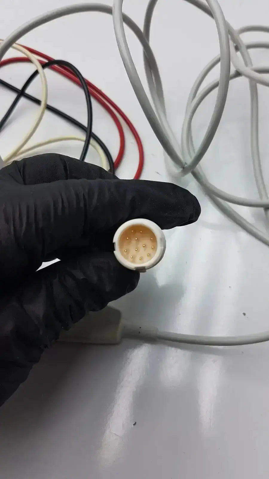 White plastic Philips M1673A connector with multiple gold-colored pins for trunk cable ICU leadset use