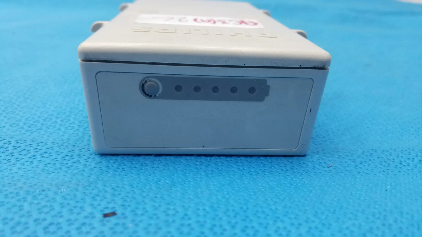 Gray plastic philips m3538a heartstart mrx lithium ion battery with circular button and five indicator lights for medical equipment