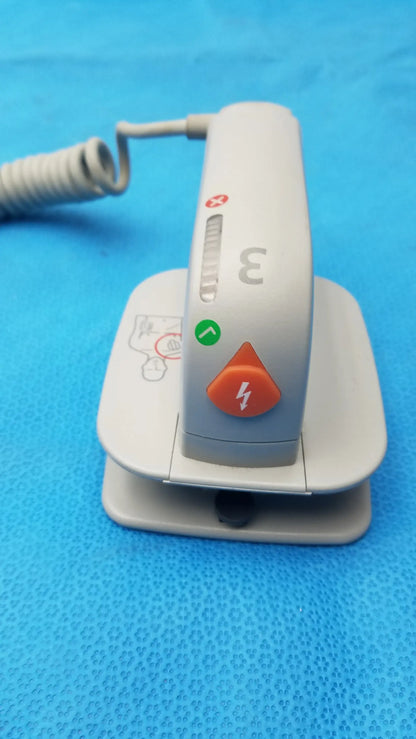 Gray medical defibrillator with orange power button and green indicator light for Philips M3543A water resistant paddles medical equipment