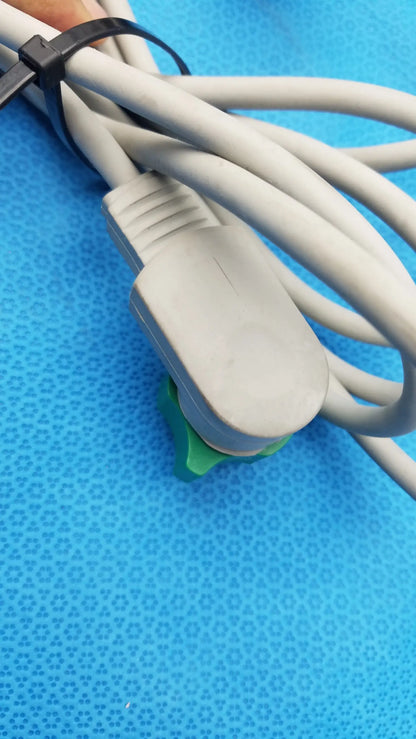 Gray power cord with molded plug secured by black zip tie resting on green clip of philips m3543a water resistant paddle