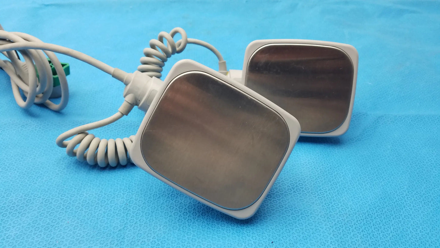 Two metallic-surfaced square electrode pads with white frames and gray cables for philips m3543a water resistant medical equipment