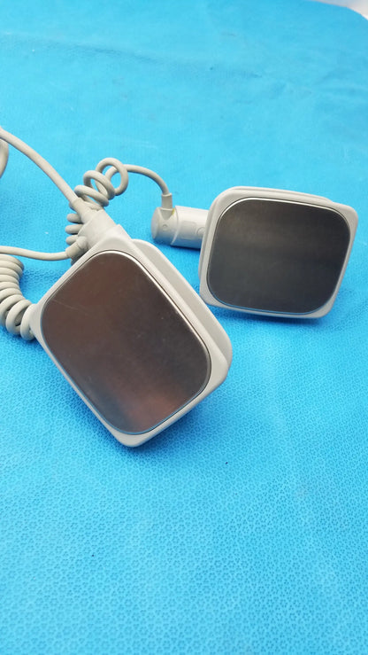White rectangular philips m3543a water resistant ultrasound transducers with dark reflective surfaces and coiled gray cables medical equipment