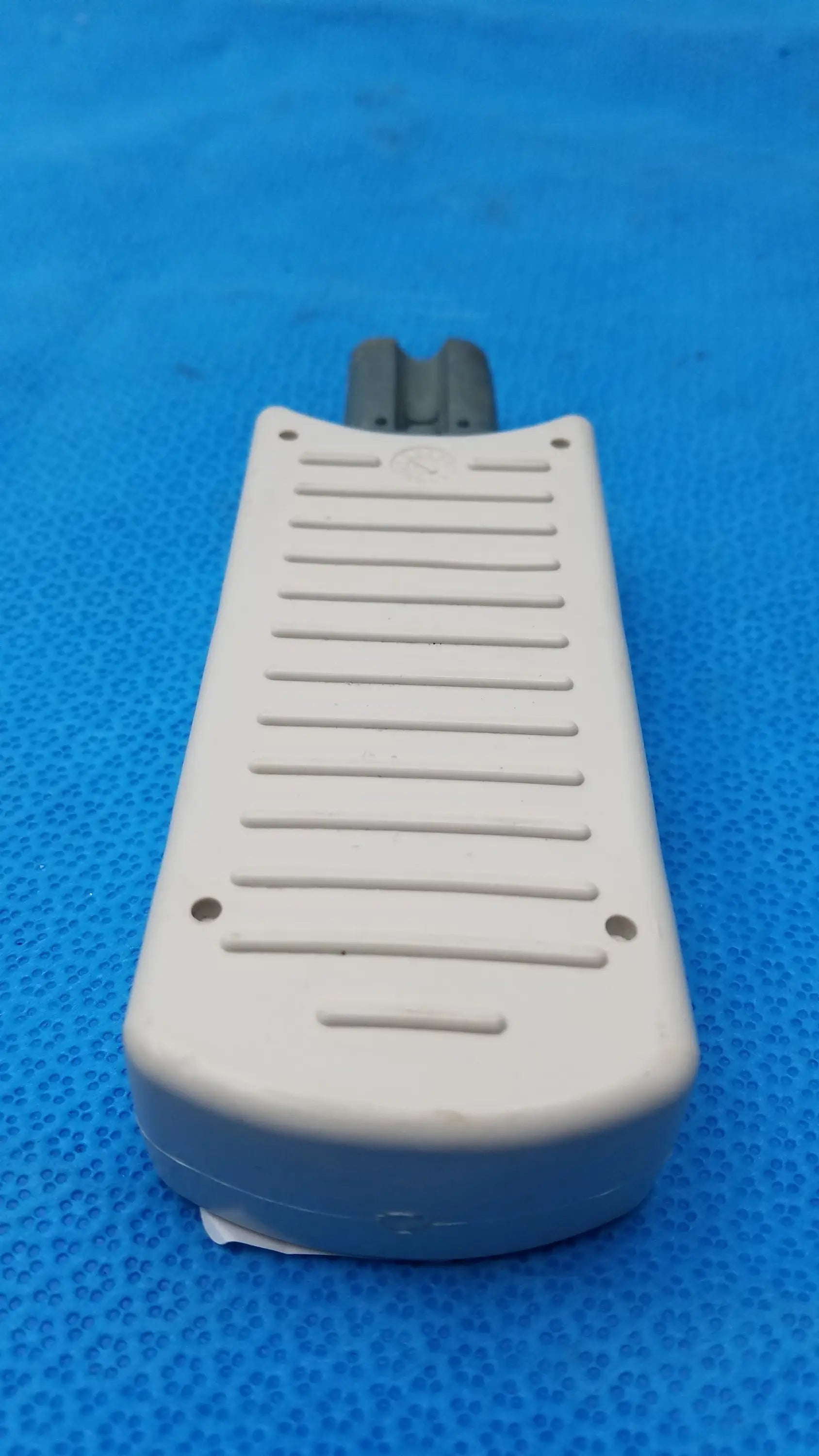 Off-white plastic foot pedal with textured ribbed surface and dark gray connector for philips m3725a test load 50 ohm medical equipment