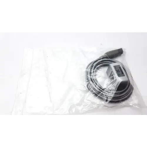 Gray coiled cable with a rectangular connector housing, wrapped in clear plastic packaging.