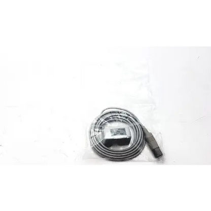 Gray coiled cable with a black rectangular connector and a metallic plug end, packaged in clear plastic