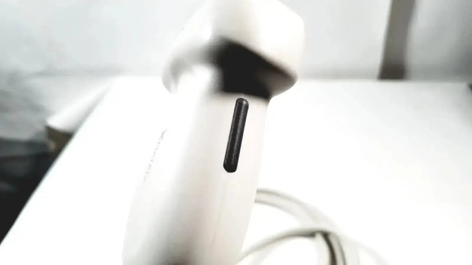 White handheld Philips X6-1 Matrix Array ultrasound transducer probe with black rectangular vent on its side