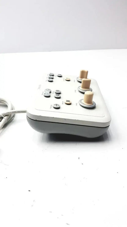Gray and beige Phillips operator imaging module mono c controller with three wooden knobs, buttons, and coiled cable