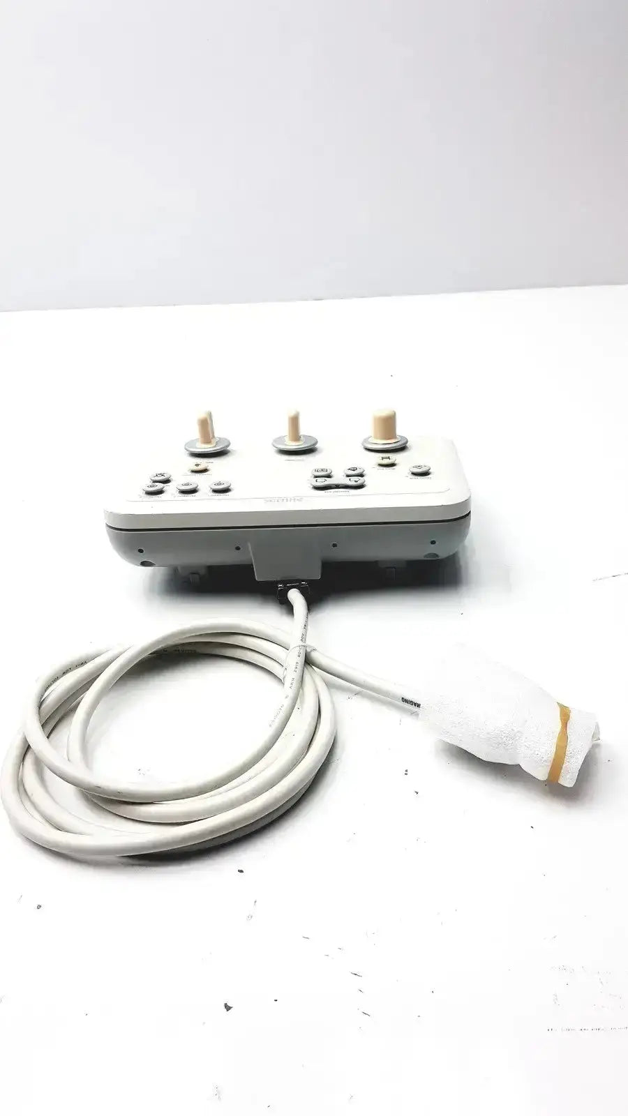 Gray Philips operator imaging module mono c controller with three beige knobs and a coiled white cable on control panel