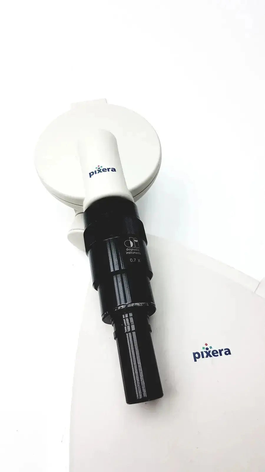White and black pixera pvc-100c microscope camera with sleek cylindrical design and diagnostic instruments for hospital surplus use