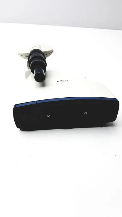 White and black prima microscope with blue accent base featuring pixera pvc-100c microscope camera and diagnostic instruments for hospital surplus use