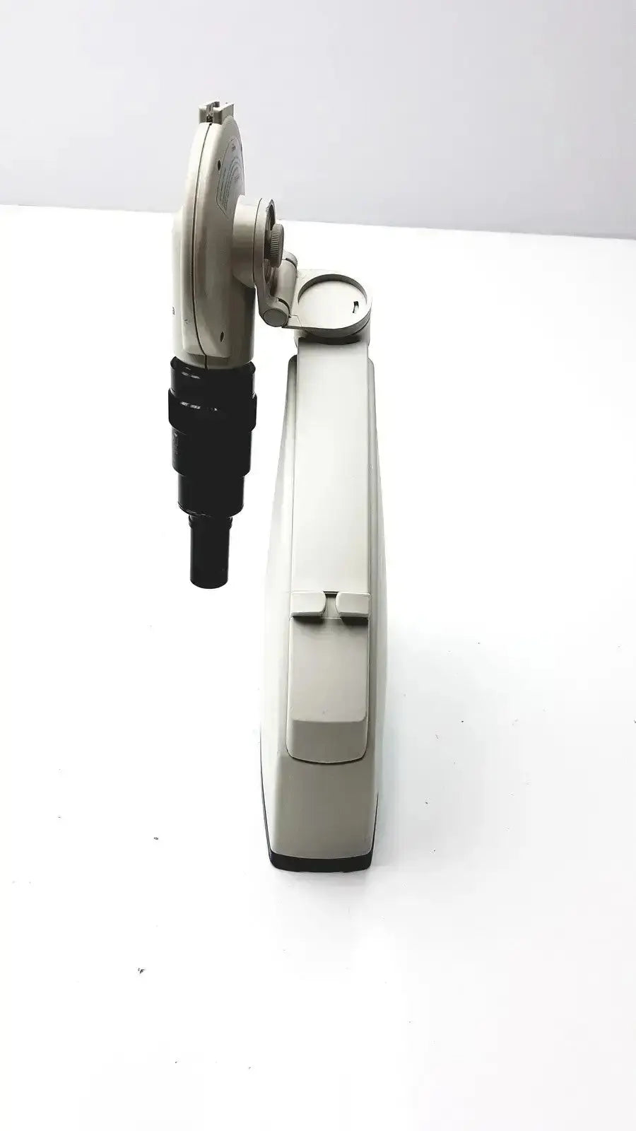 Beige and black handheld microscope camera with articulated arm featuring diagnostic instruments for hospital surplus use