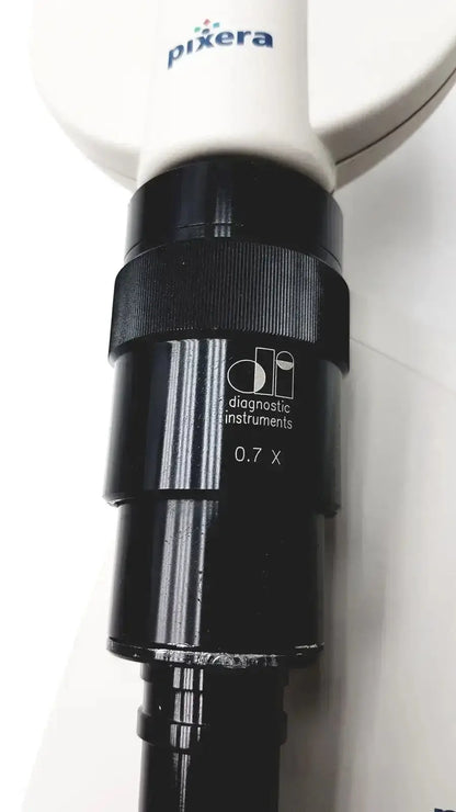 Black 0.7x magnification lens with textured grip and pixera branding on white handle by diagnostic instruments for microscope camera use