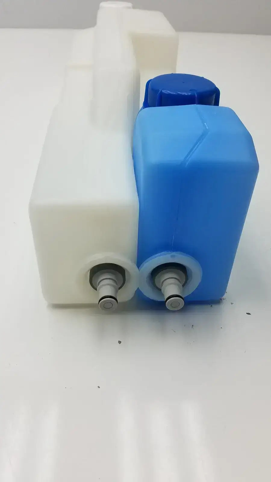 Plastic universal tank with 2 blue caps made of blue and white plastic with metal fittings for fluid storage