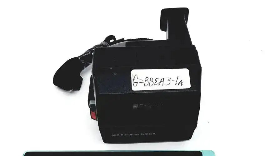 Black plastic handheld polaroid 600 business edition instant camera with label g=bbea3-1a from hospital surplus