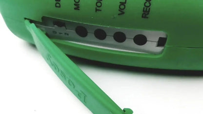 Green plastic posey sitter elite device with sliding cover revealing circular disp mode tool vol record buttons