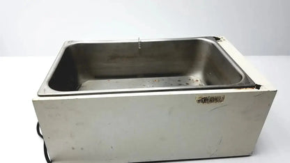 Stainless steel rectangular ultrasonic cleaner with white plastic base and wear edges in precision 51221050 water bath for pre owned medical equipment sale