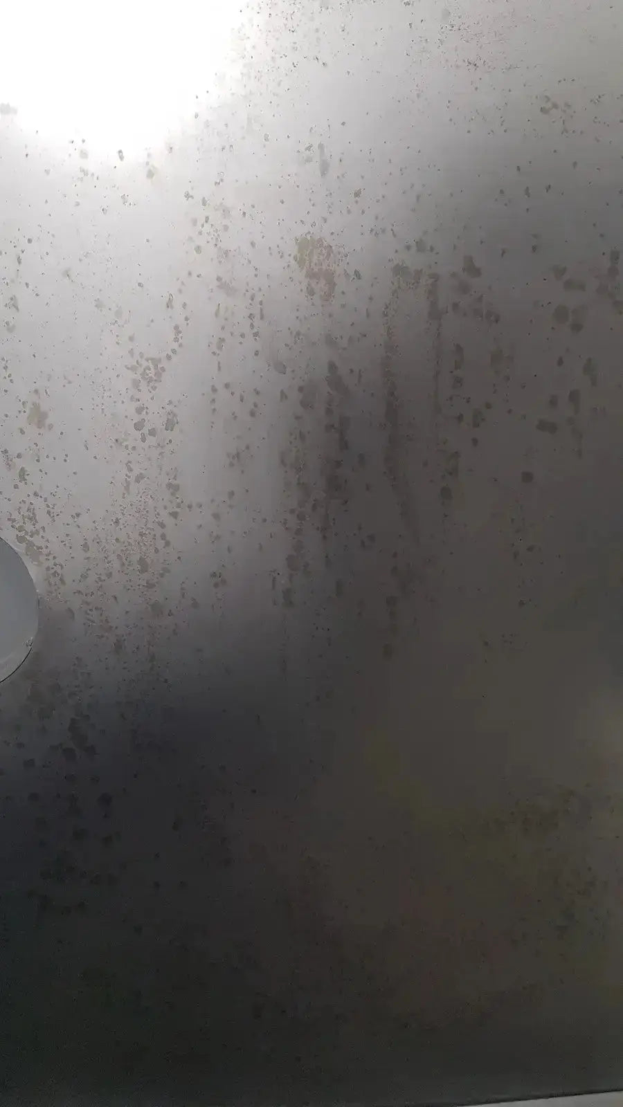 Foggy smudged glass surface with faint streaks and circular reflection of napco precision series 5425 co2 incubator