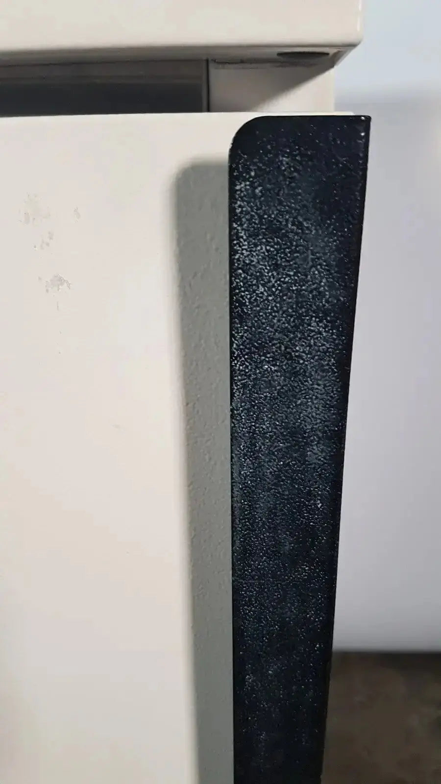 Black textured side panel of a white napco precision series co2 incubator model ot-100z for lab use