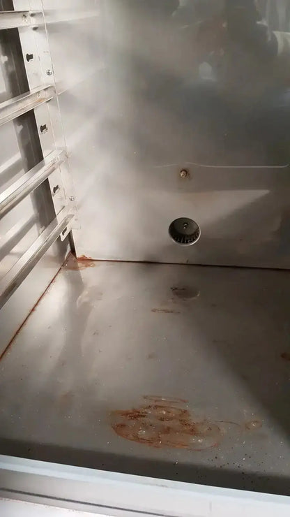 Stainless steel interior of napco precision series co2 incubator with visible rust stains and circular drain hole