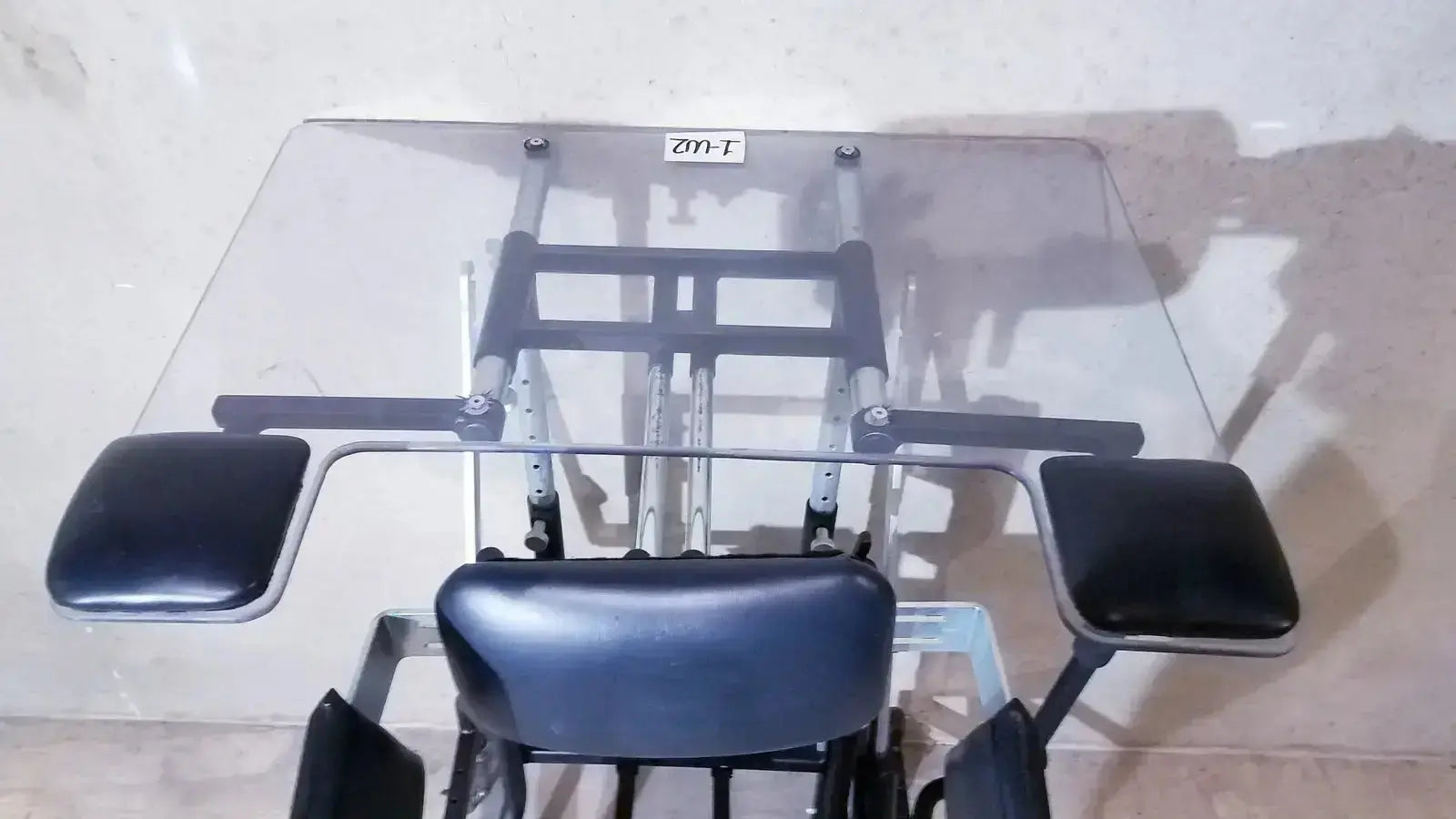 Prime engineering grandstand iii modular standing system with black padded seat and armrests on metallic frame and glass tabletop