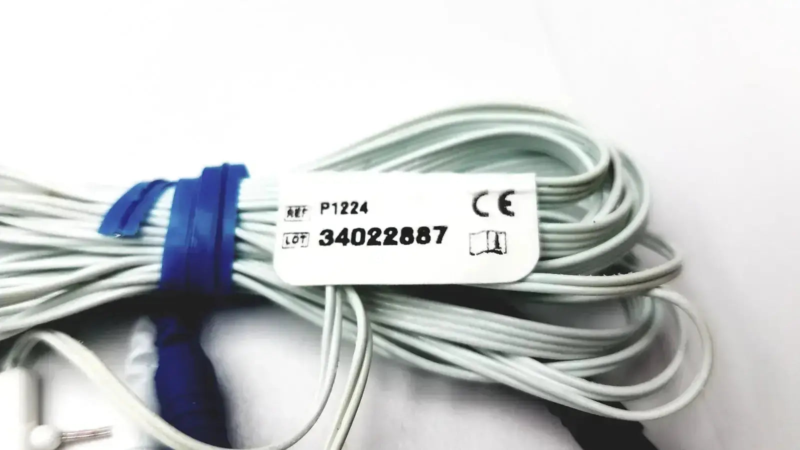 A bundle of light gray pro-tech p1224 thermocouple nasal oral airflow sensor cables tied with a blue band and white label