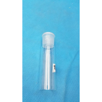 Clear plastic vial with a white cap and multiple thin, transparent needles inside.