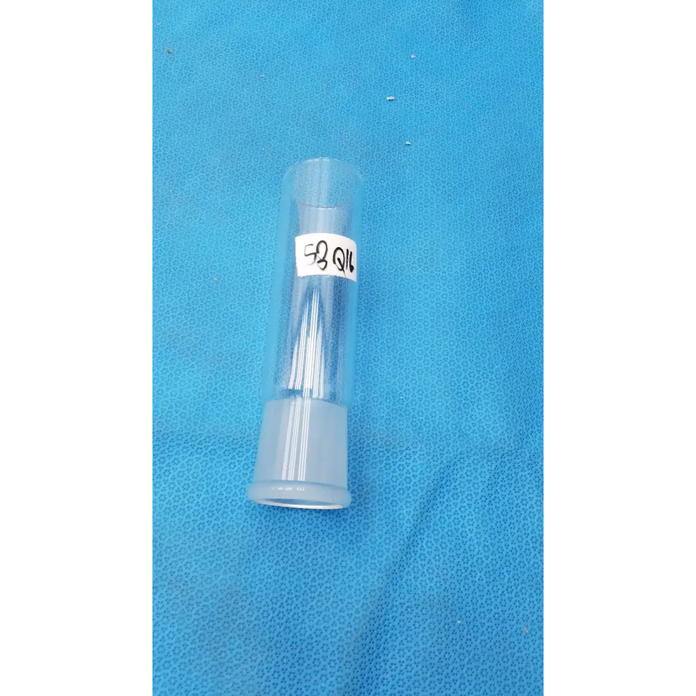 Clear plastic tube with a white label reading ’58 qil’ and containing several thin, transparent needles.