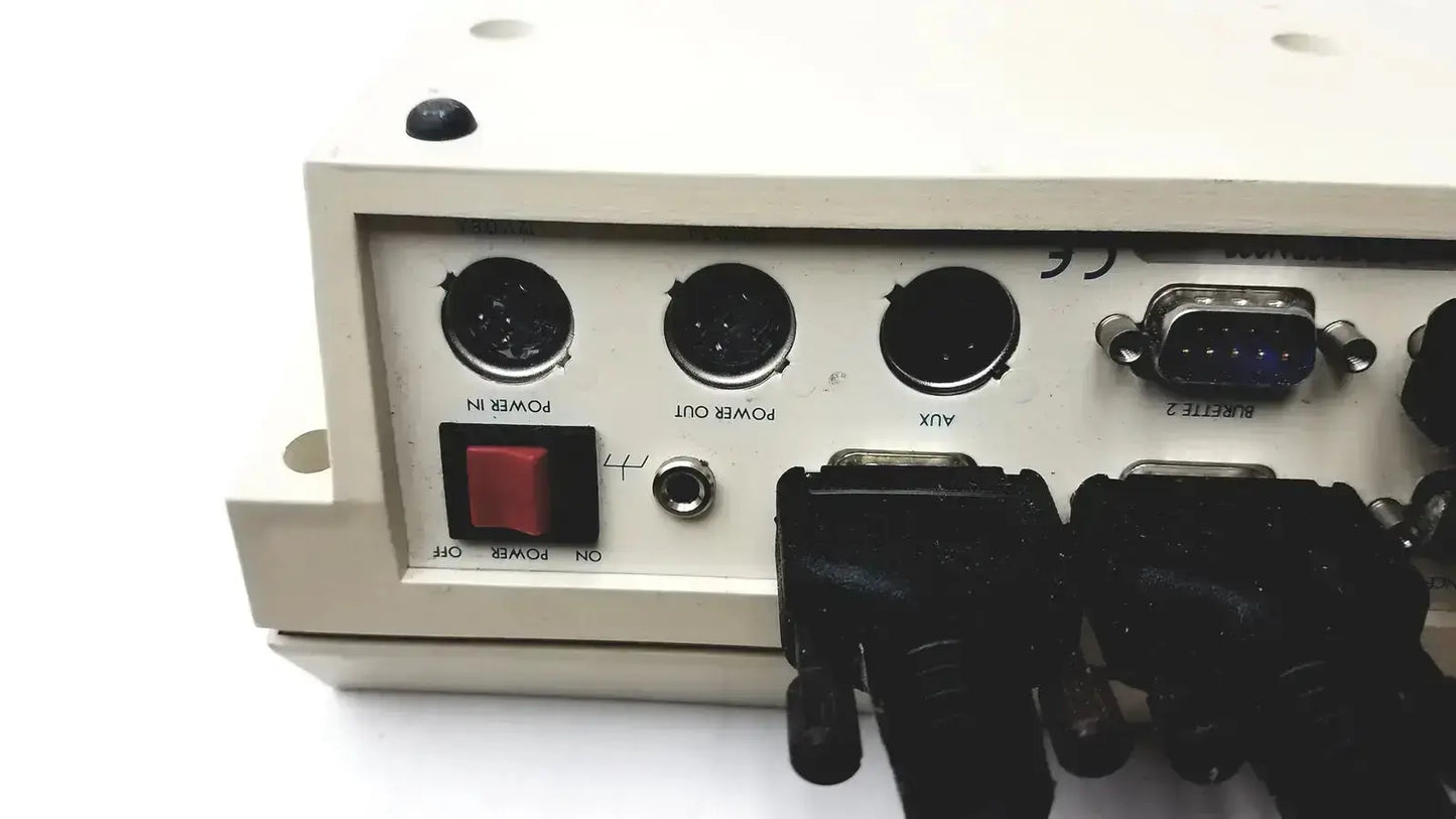 Beige industrial-grade radiometer copenhagen tim900 titration manager back with black power and aux ports and blue db9 serial port