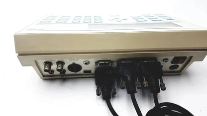 Beige radiometer copenhagen tim900 titration manager rear panel with multiple black cables connected to ports