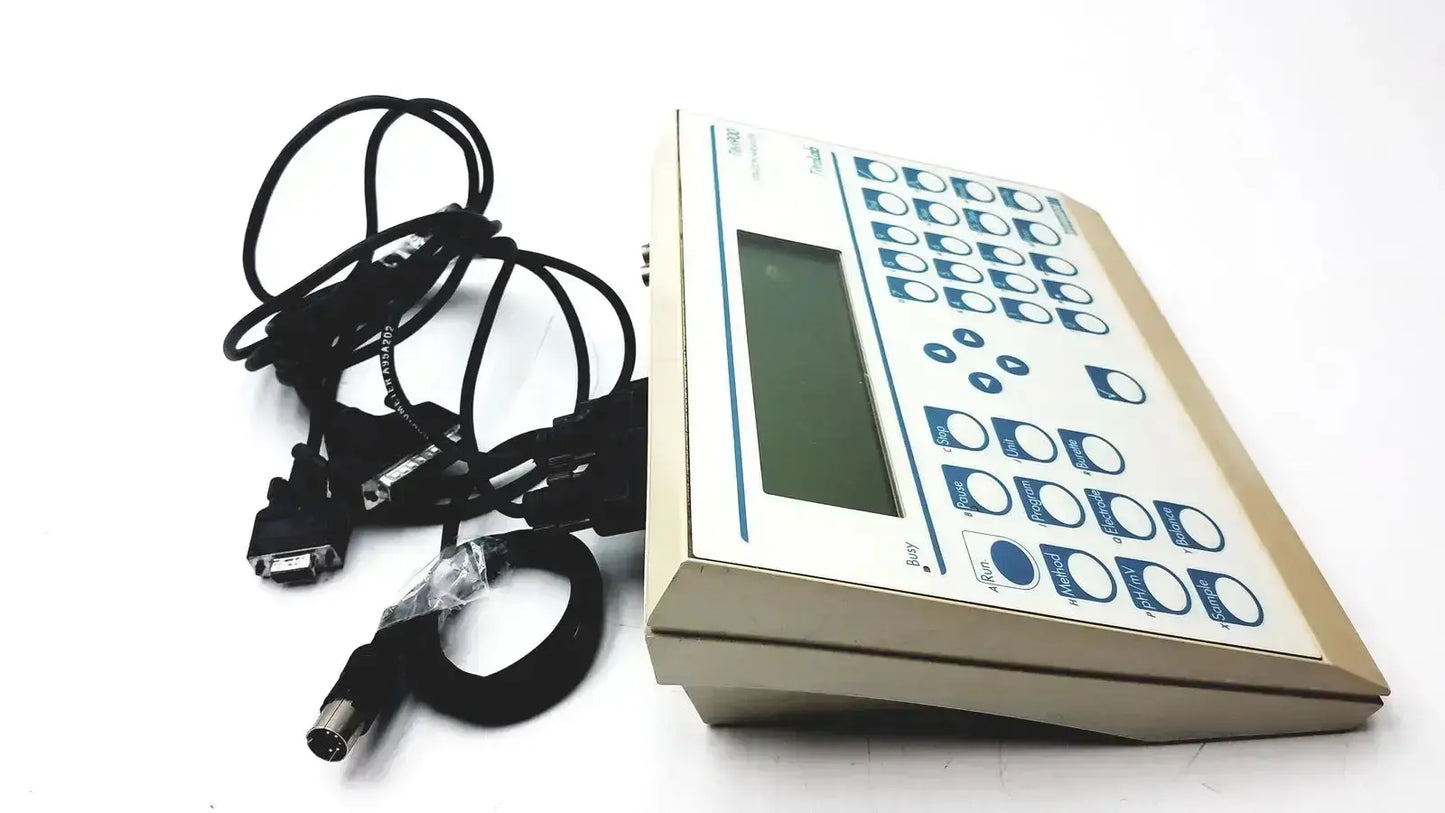 Beige radiometer copenhagen tim900 titration manager with rectangular screen blue-labeled buttons and coiled black cables