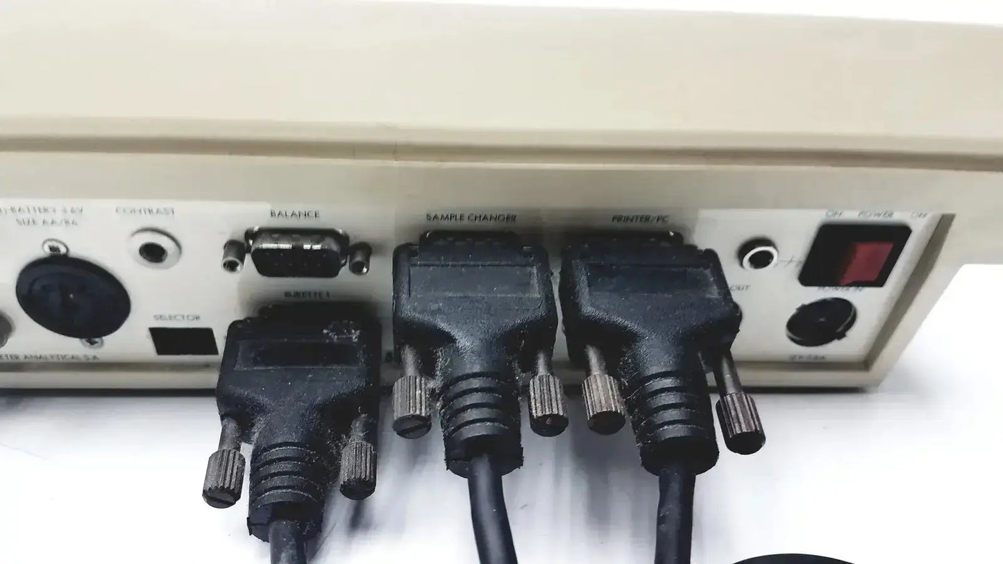 Black rugged cables with metallic thumbscrews connected to the beige rear panel of radiometer copenhagen tim900 titration manager