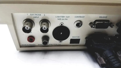 Beige plastic back panel of radiometer copenhagen tim900 titration manager with labeled electrode inputs battery slot and control knobs
