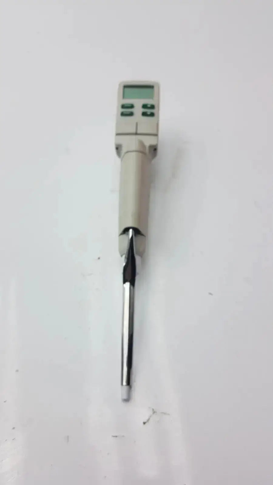 Beige rainin edp3 plus electronic digital pipette with metallic tip and green display screen calibrated for precision use