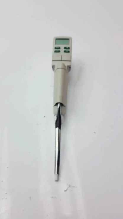 Beige rainin edp3 plus electronic digital pipette with metallic tip and green display screen calibrated for precision use