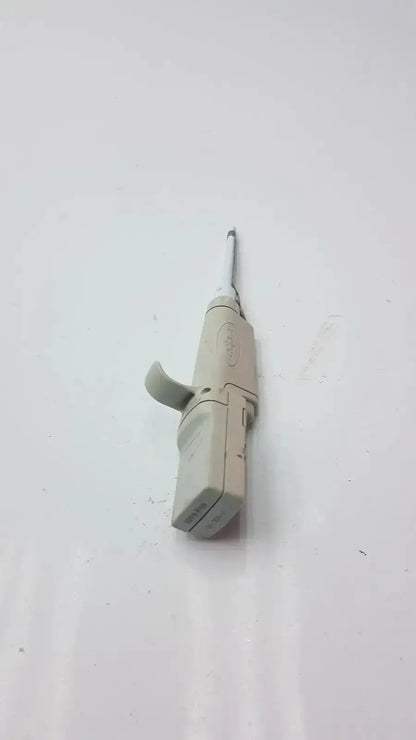 Beige plastic rainin edp3 plus electronic digital pipette calibrated with a slender metallic nozzle for precise dosing