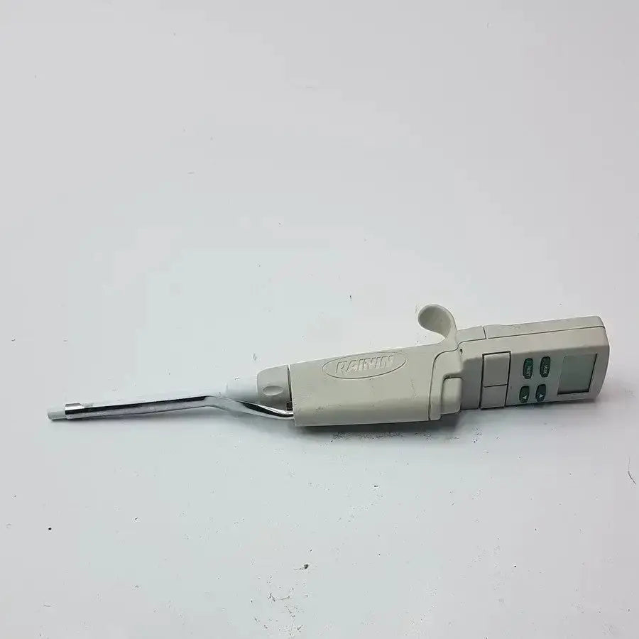 Beige plastic rainin edp3 plus electronic digital pipette calibrated with metallic tip and control buttons for precision use
