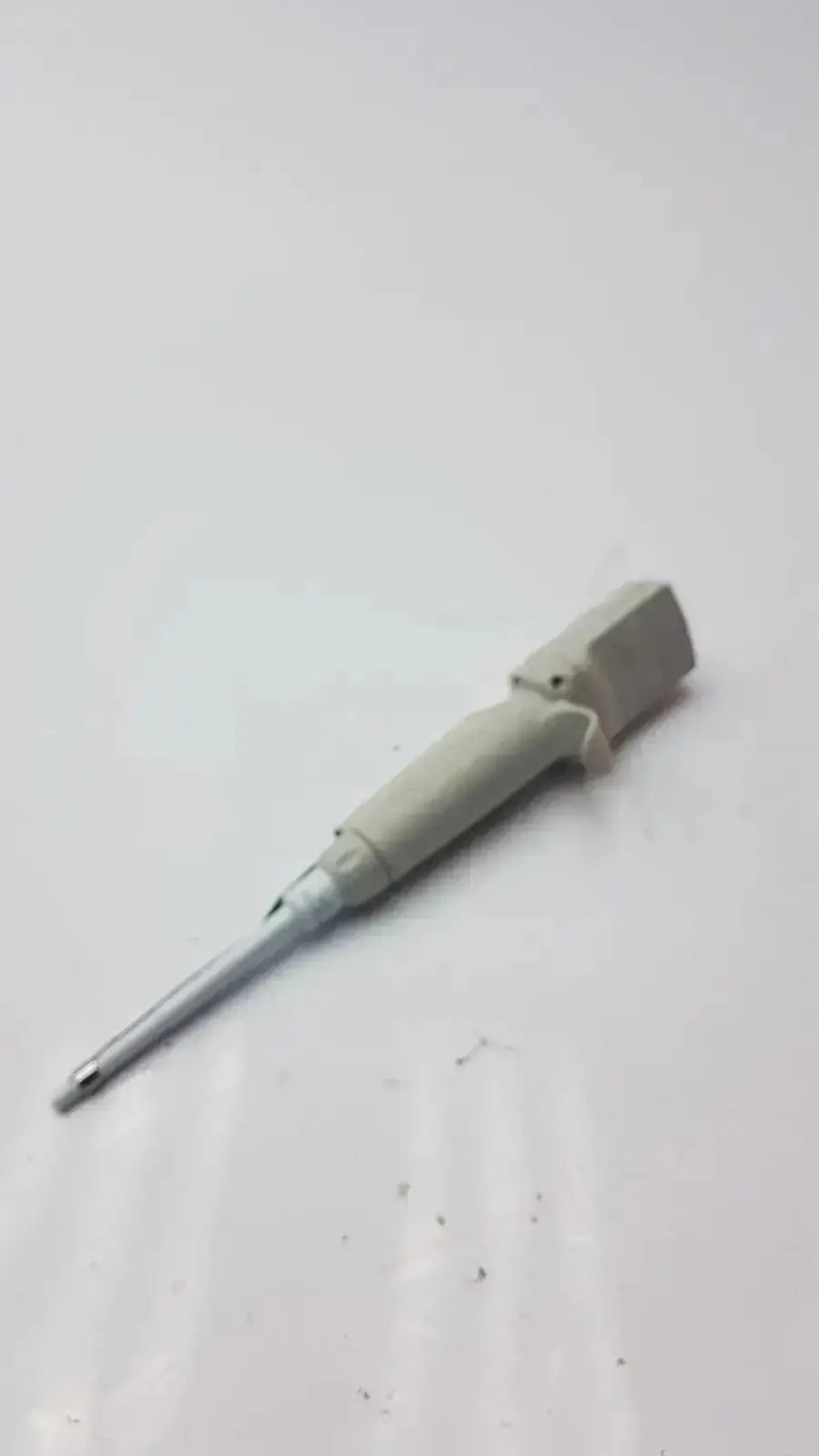 A beige plastic-handled screwdriver with a metallic shaft and hexagonal tip used for rainin edp3 plus digital pipette calibrated maintenance