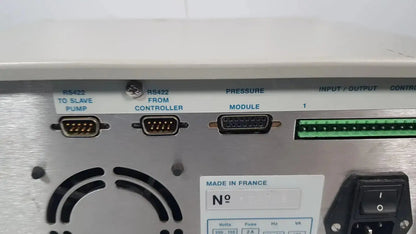 Silver industrial control panel with labeled ports and green connector strip on the back of rainin hpxl solvent delivery system