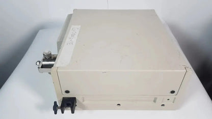 Beige rectangular rainin hpxl solvent delivery system with metallic fittings and black clamp for solvent delivery use