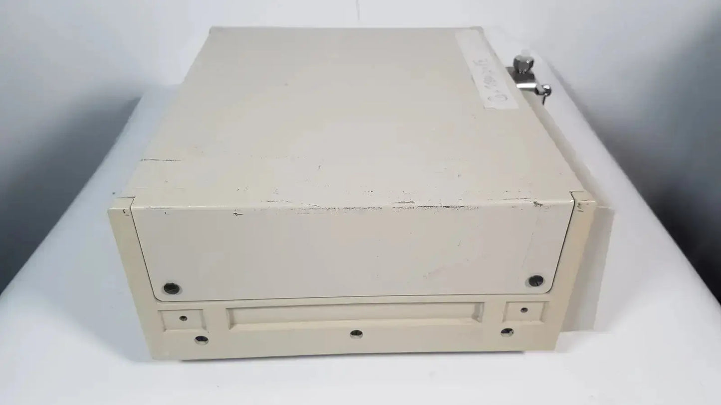 Beige metal file cabinet with lock and wear marks for secure storage in rainin hpxl solvent delivery system