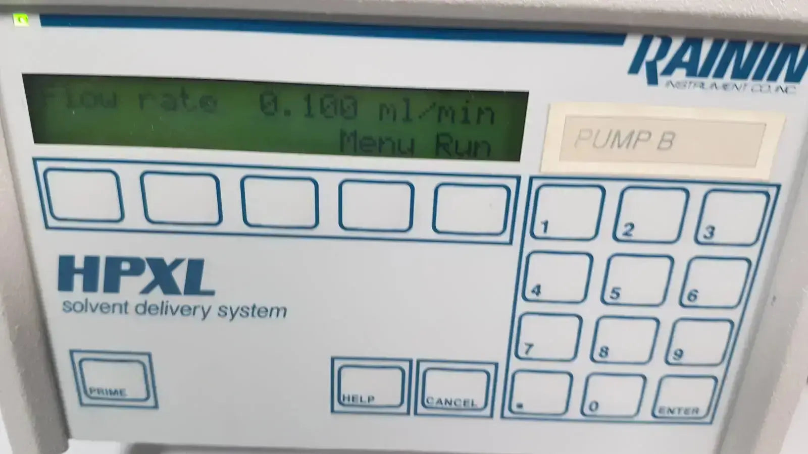 White rainin hpxl solvent delivery system control panel with green lcd screen showing flow rate and keypad for solvent delivery