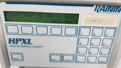 White rainin hpxl solvent delivery system control panel with green lcd screen showing flow rate and keypad for solvent delivery