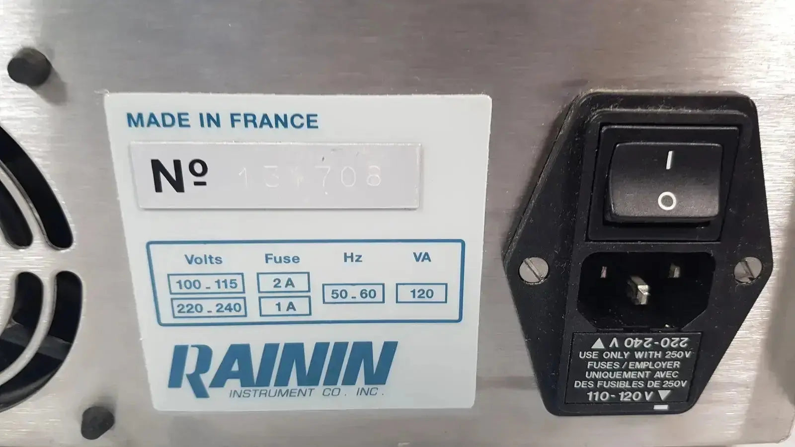 Black plastic power switch with labeled on off positions and safety warnings on stainless steel panel for rainin hpxl solvent delivery system