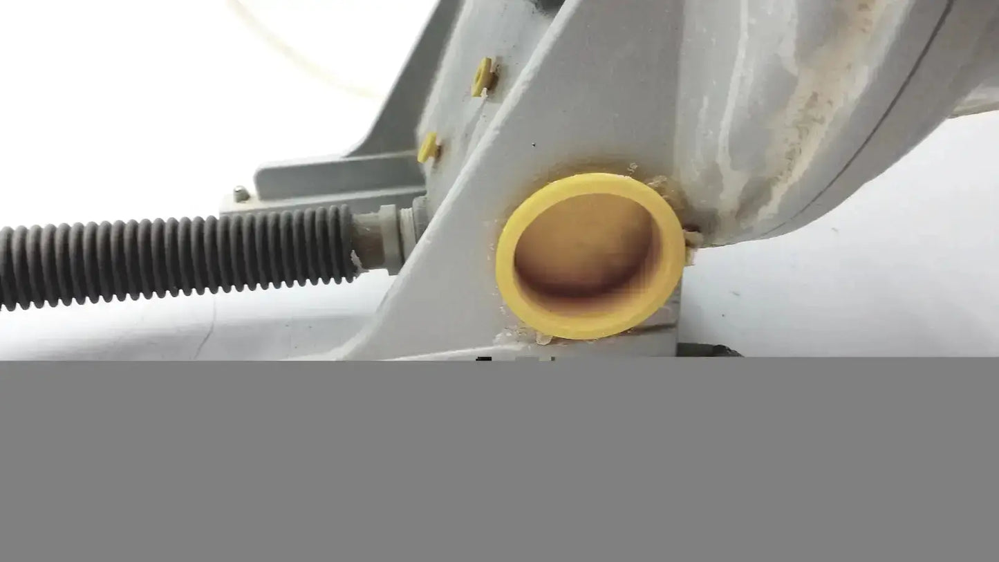 Yellow plastic pipe coupling attached to metallic appliance on ray foster mt12 dental lab model trimmer back side