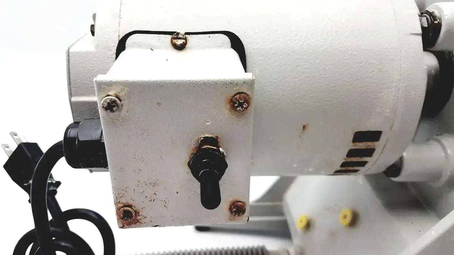 White rectangular electrical control box with black toggle switch and rusted screws on ray foster mt12 dental lab model trimmer