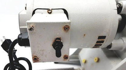 White rectangular electrical control box with black toggle switch and rusted screws on ray foster mt12 dental lab model trimmer