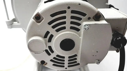 White industrial motor with black ventilation slats and metallic bolts on the back of Ray Foster MT12 dental lab model trimmer