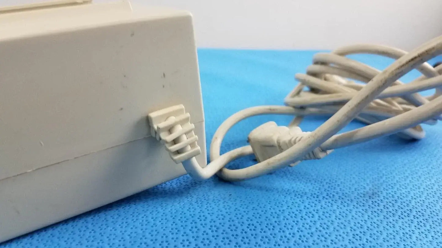 White plastic raydow rd-b-24 multi-function control box power adapter with coiled beige cable for reuse medical equipment