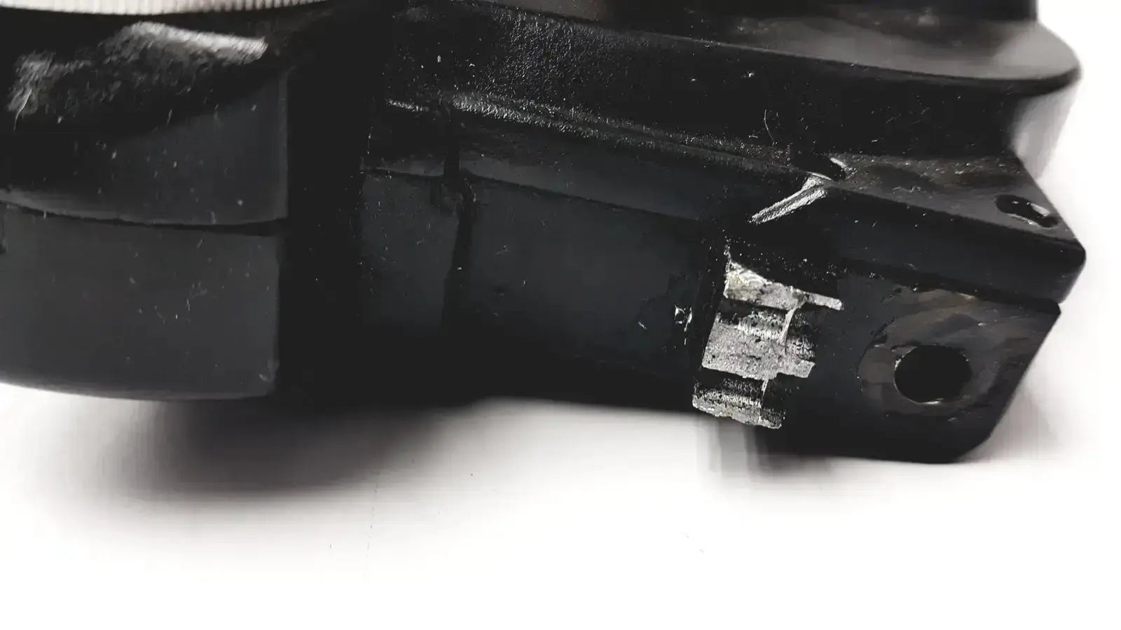 Black plastic Reichert minus cylinder phoropter with visible white gear and circular hole showing some damage back side