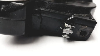Black plastic Reichert minus cylinder phoropter with visible white gear and circular hole showing some damage back side
